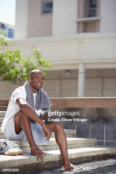 man relaxing listening to mp3 player - oliver eltinger stock pictures, royalty-free photos & images