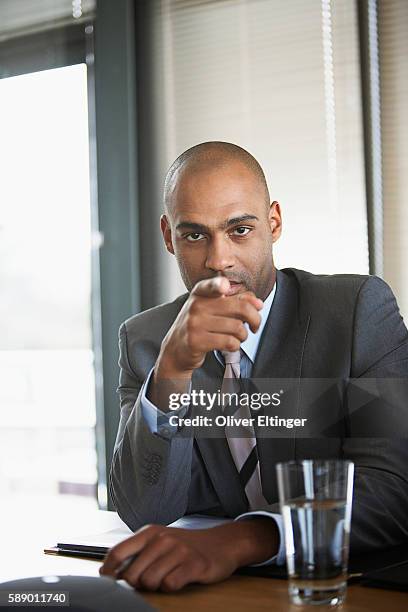 businessman pointing finger - oliver eltinger stock pictures, royalty-free photos & images