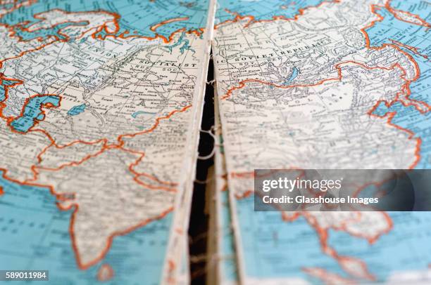 old torn atlas map of eurasia - china russia stock pictures, royalty-free photos & images