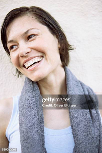 smiling woman with towel around neck - oliver eltinger stock pictures, royalty-free photos & images