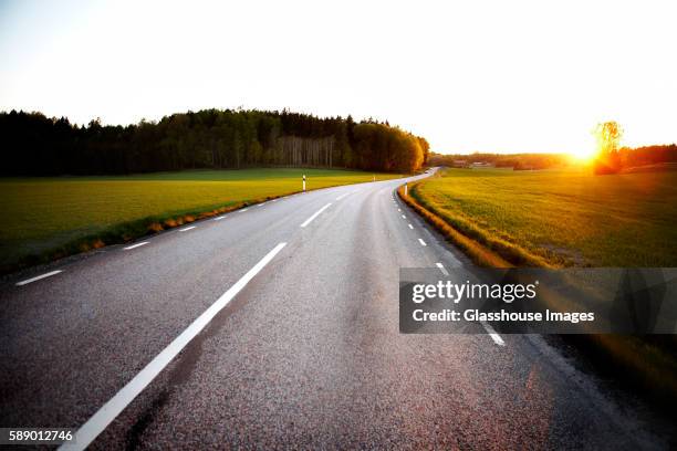 rural road at sunrise, sweden - stockholm sun stock pictures, royalty-free photos & images
