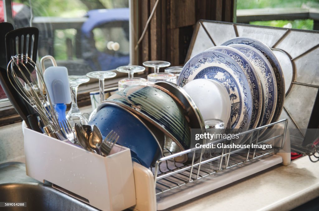 Clean Dishes in Drying Rack on Kitchen Counter