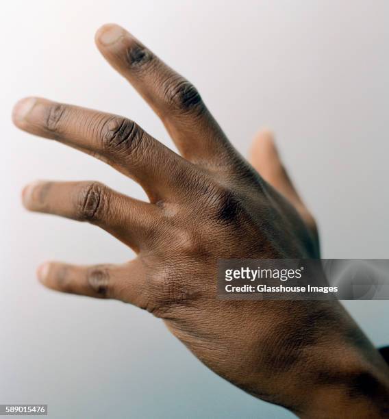 reaching out hand - african american hand stock-fotos und bilder