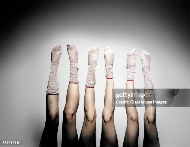 three women legs with striped socks sticking up in air - stockings feet stock pictures, royalty-free photos & images