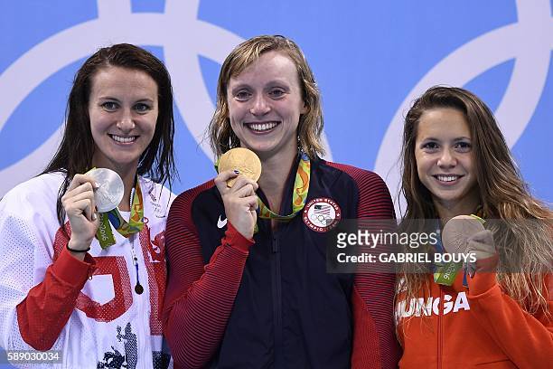 Gold medallist USA's Katie Ledecky poses with silver medallist Britain's Jazz Carlin and bronze medallist Hungary's Boglarka Kapas on the podium of...