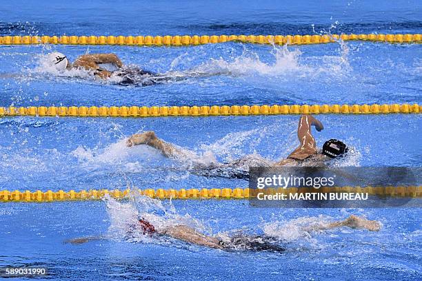 S Katie Ledecky crosses Hungary's Katinka Hosszu and Canada's Hilary Caldwell during the Women's 800m Freestyle Final during the swimming event at...