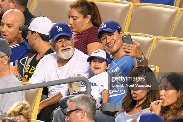 Mario Michael Lopez, Sr., Dominic Lopez and Mario Lopez attend a baseball game between the Pittsburgh Pirates and the Los Angeles Dodgers at Dodger...