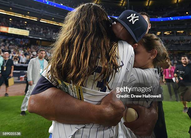 Alex Rodriguez of the New York Yankees hugs his daughter Natasha and Ella after the game against the Tampa Bay Rays at Yankee Stadium on August 12,...