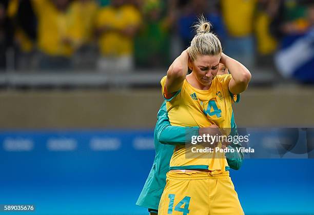 Alanna Kennedy of Australia is embraced after their 0-0 loss to Brazil during the Women's Football Quarterfinal match at Mineirao Stadium on Day 7 of...