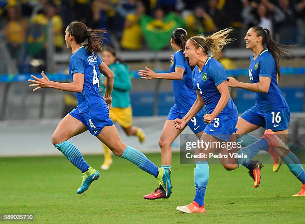 Rafaelle, Monica, Beatriz and Andressa Alves of Brazil celebrate their 0-0 win over Australia during the Women's Football Quarterfinal match at...