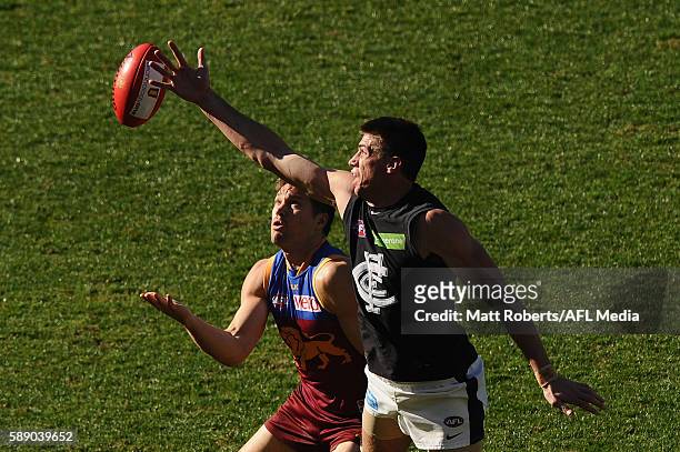 Matthew Kreuzer of the Blues competes for the ball against Stefan Martin of the Lions during the round 21 AFL match between the Brisbane Lions and...