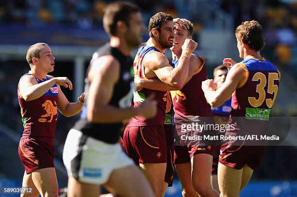 Michael Close of the Lions celebrates kicking a goal with team mates during the round 21 AFL match between the Brisbane Lions and the Carlton Blues...