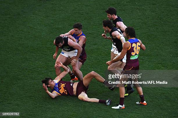 Players of the Lions and the Blues wrestle during the round 21 AFL match between the Brisbane Lions and the Carlton Blues at The Gabba on August 13,...