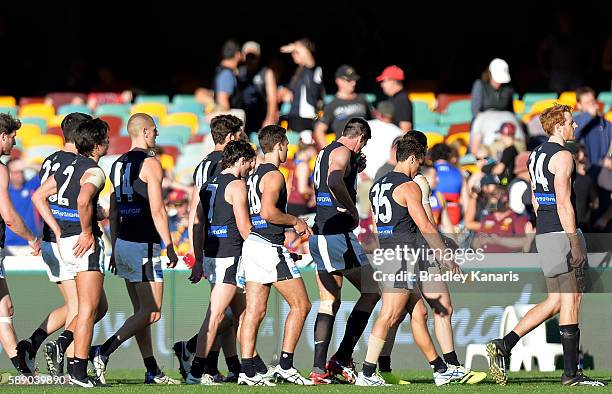 Carlton players look dejected after losing the round 21 AFL match between the Brisbane Lions and the Carlton Blues at The Gabba on August 13, 2016 in...