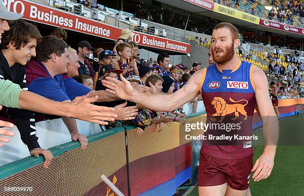 Daniel Merrett of the Lions celebrates with fans after the round 21 AFL match between the Brisbane Lions and the Carlton Blues at The Gabba on August...