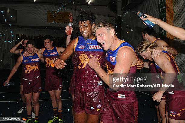 Archie Smith and Jarrad Jansen of the Lions celebrate victory with team mates after the round 21 AFL match between the Brisbane Lions and the Carlton...