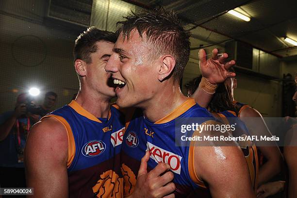 Jarrad Jansen of the Lions celebrates victory with team mates after the round 21 AFL match between the Brisbane Lions and the Carlton Blues at The...
