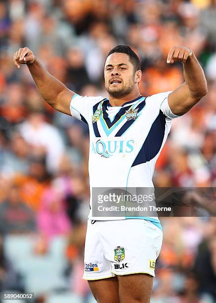 Jarryd Hayne of the Titans celebrates after kicking a drop goal to win the match during the round 23 NRL match between the Wests Tigers and the Gold...