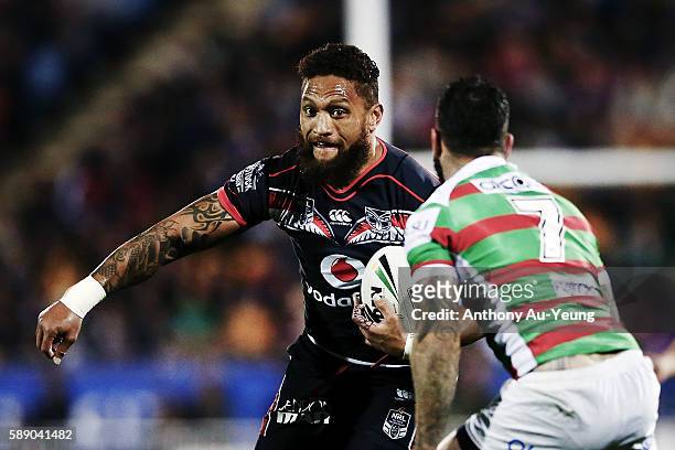 Manu Vatuvei of the Warriors makes a run at Adam Reynolds of the Rabbitohs during the round 23 NRL match between the New Zealand Warriors and the...