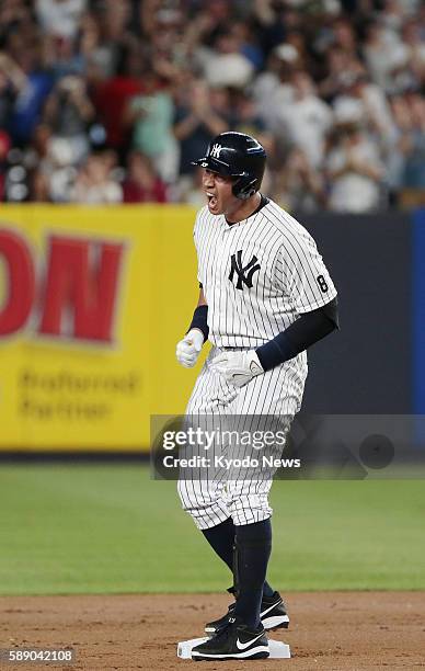 Alex Rodriguez stands on second base after hitting an RBI double in the first inning of the New York Yankees' 6-3 win over the Tampa Bay Rays at...