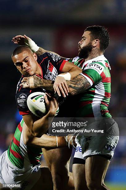 Tuimoala Lolohea of the Warriors is tackled by Adam Reynolds of the Rabbitohs during the round 23 NRL match between the New Zealand Warriors and the...