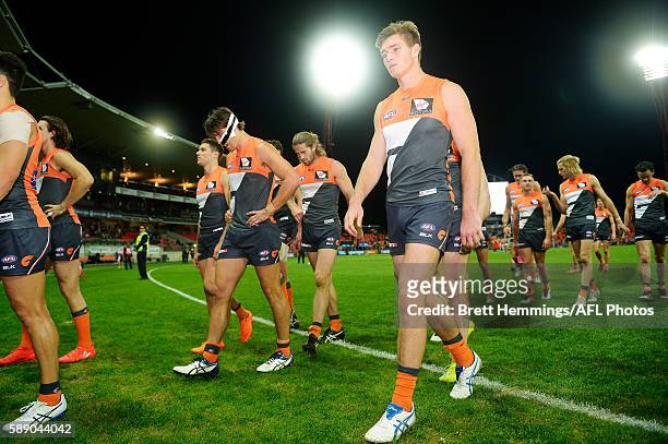 Giants players leave the field after defeat during the round 21 AFL match between the Greater Western Sydney Giants and the West Coast Eagles at...