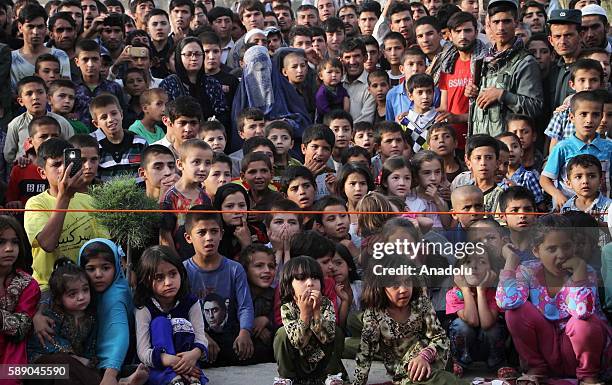 Children watch Internally displaced Afghan children's performance during the 11th Afghanistan National Juggling Championship organized by the Mobile...