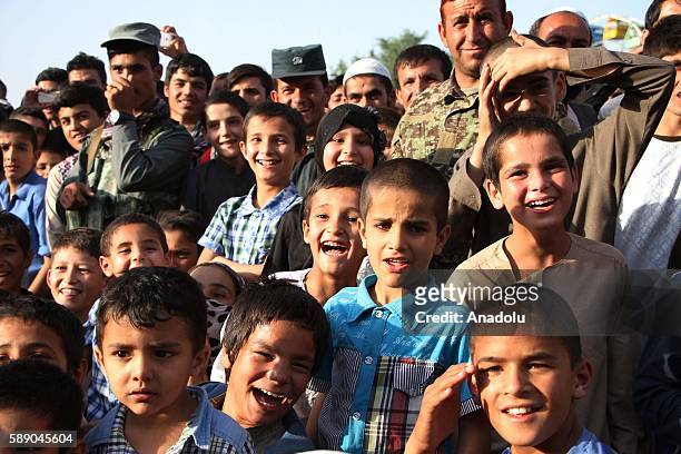 Children watch Internally displaced Afghan children's performance during the 11th Afghanistan National Juggling Championship organized by the Mobile...