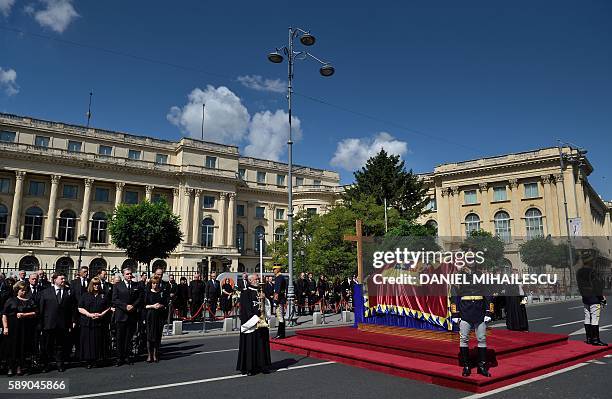 Regiment soldiers guard the coffin of the late Queen Anne of Romania at the Royal Palace, now The Art Museum of Romania, as members of the Royal...
