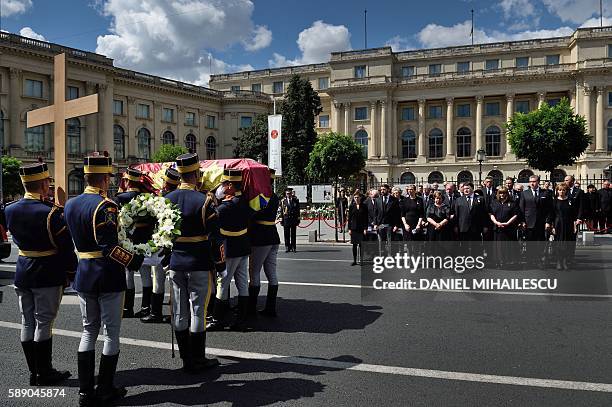 Guard regiment soldiers carry the coffin of the late Queen Anne of Romania at the Royal Palace, now The Art Museum of Romania, as members of the...