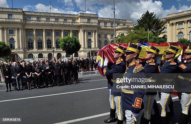 Guard regiment soldiers carry the coffin of the late Queen Anne of Romania at the Royal Palace, now The Art Museum of Romania, as members of the...