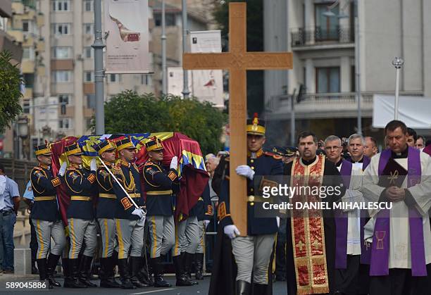 Guard regiment soldiers carry the coffin of late Queen Anne of Romania at the Royal Palace, now The Art Museum of Romania, as members of the Royal...