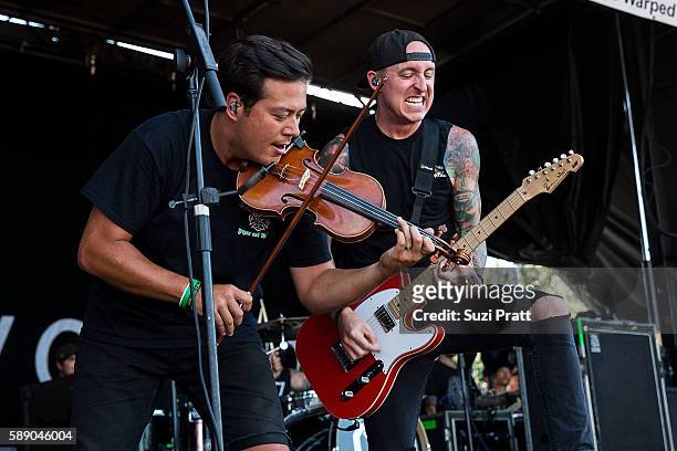 Sean Mackin and Ryan Key of Yellowcard perform at the Vans Warped Tour at White River Amphitheatre on August 12, 2016 in Auburn, Washington.