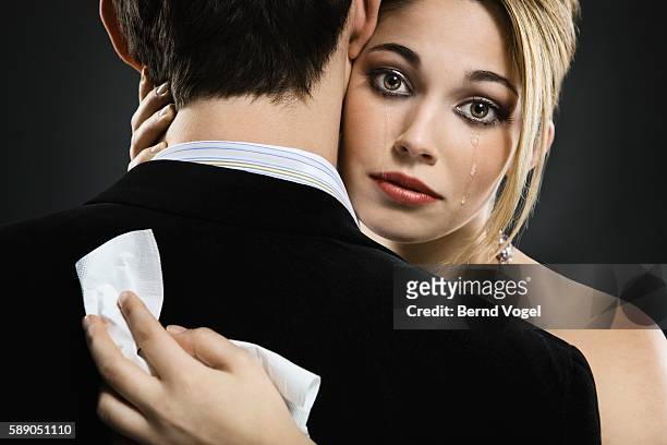 woman hugging man and crying - teardrop foto e immagini stock