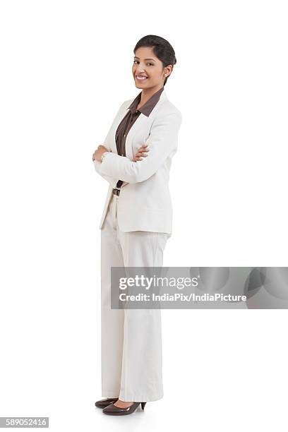 full length portrait of happy confident businesswoman with arms crossed isolated over white background - indian corporate women background stockfoto's en -beelden