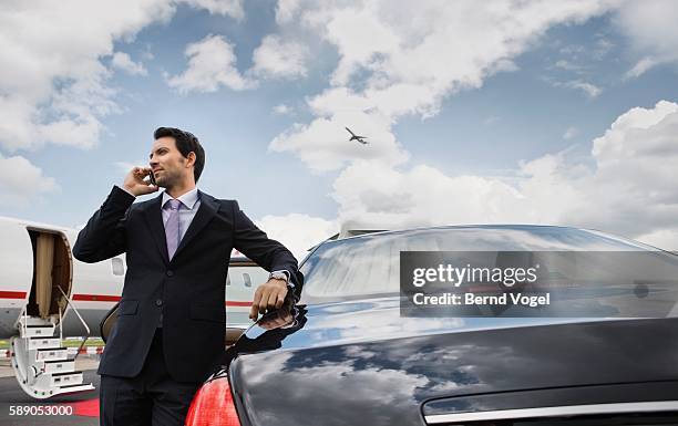 businessman on cell phone at airport - rich celebrities stock pictures, royalty-free photos & images