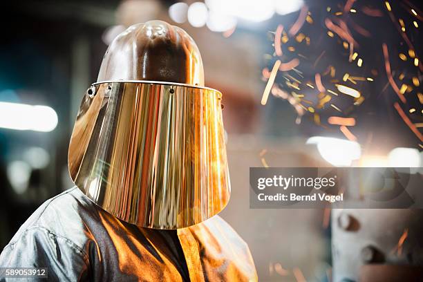 steel worker in protective headwear - metal industry stock-fotos und bilder