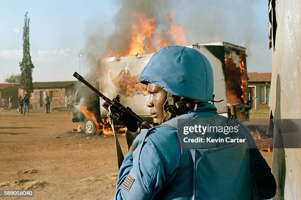 National Peacekeeping Force soldier at the scene of a burning bakery truck in Katlehong township.