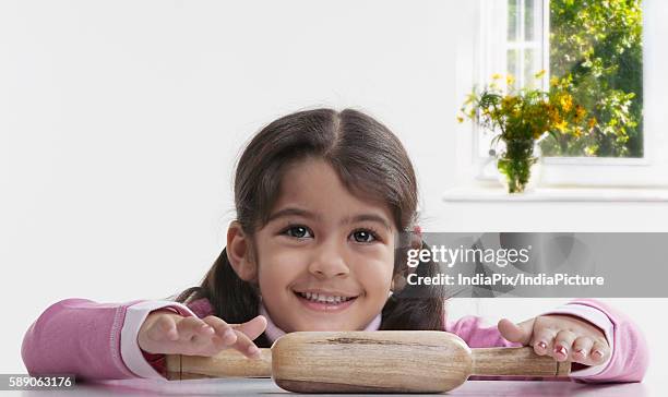 girl with a rolling pin - asian pin up girls stockfoto's en -beelden