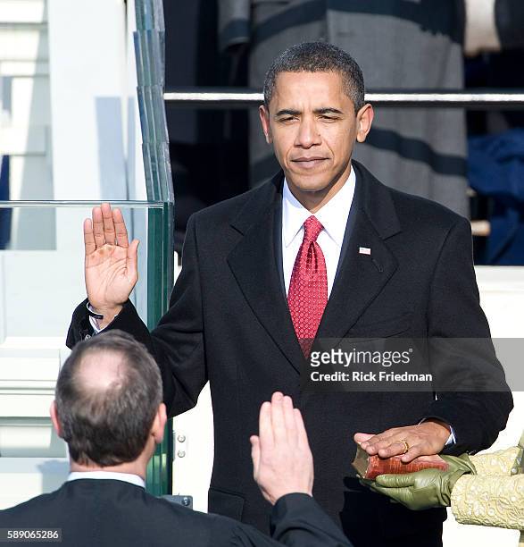 Barack Obama is sworn in by Chief Justice John Roberts as the 44th president of the United Statesas on the West Front of the Capitol as his wife...