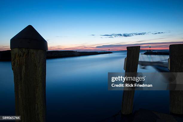 Sunset over Menemsha Sound in the town of Chilmark on Martha's Vineyard, MA over looking beach in the town of Aquinnah, formerly known at Gay Head on...