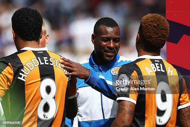 Wes Morgan of Leicester City pats Tom Huddlestone of Hull City on the back prior to kick off during the Premier League match between Hull City and...