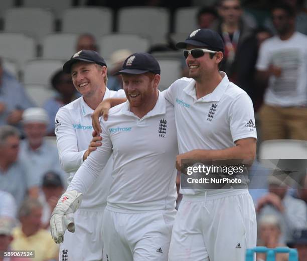 England's Jonny Bairstow celebrates his catch with England's Alastair Cook during Day Three of the Fourth Investec Test Match between England and...