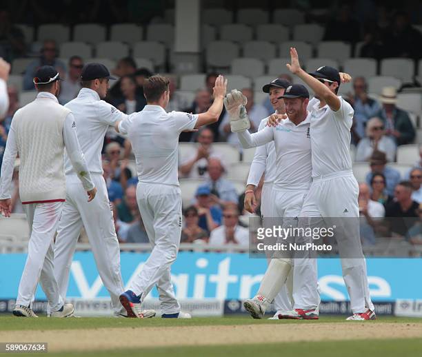 England's Jonny Bairstow celebrates his catch with England's Alastair Cook during Day Three of the Fourth Investec Test Match between England and...