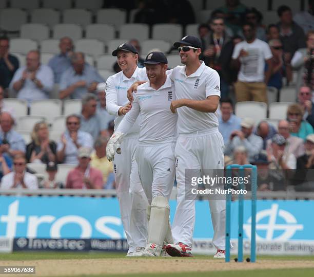 England's Jonny Bairstow celebrates his catch with England's Alastair Cook during Day Three of the Fourth Investec Test Match between England and...