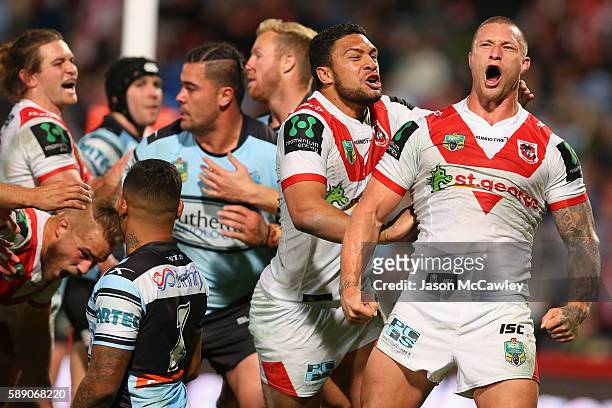 Tariq Sims of the Dragons celebrates with teammates after scoring a try during the round 23 NRL match between the St George Illawarra Dragons and the...