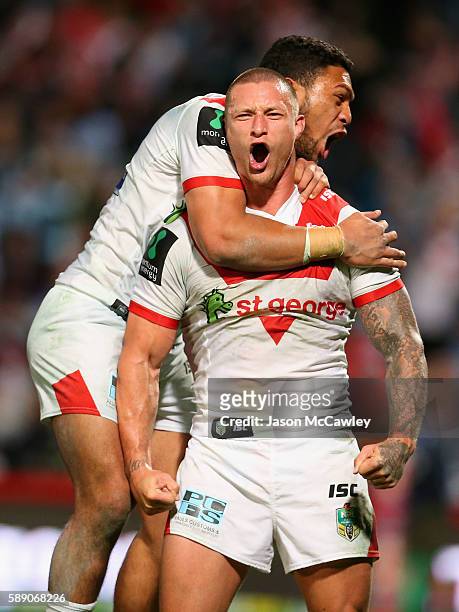 Tariq Sims of the Dragons celebrates with teammates after scoring a try during the round 23 NRL match between the St George Illawarra Dragons and the...