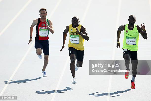 Holder da Silva of Guinea-Bissau, Wilfried Bingangoye of Gabon and Abdul Wahab Zahiri of Afghanistan competes in the Men's 100m Preliminary Round on...