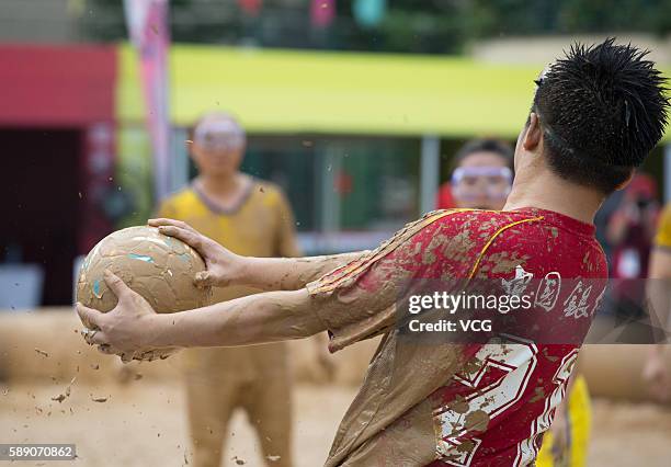 Player handles the ball during the first station match of 2016 Swamp Soccer China tournament at Yuetan Park on August 13, 2016 in Beijing, China....