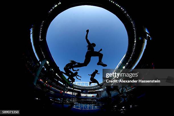 Athletes clear the water jump in the Women's 3000m Steeplechase Round 1 on Day 8 of the Rio 2016 Olympic Games at the Olympic Stadium on August 13,...